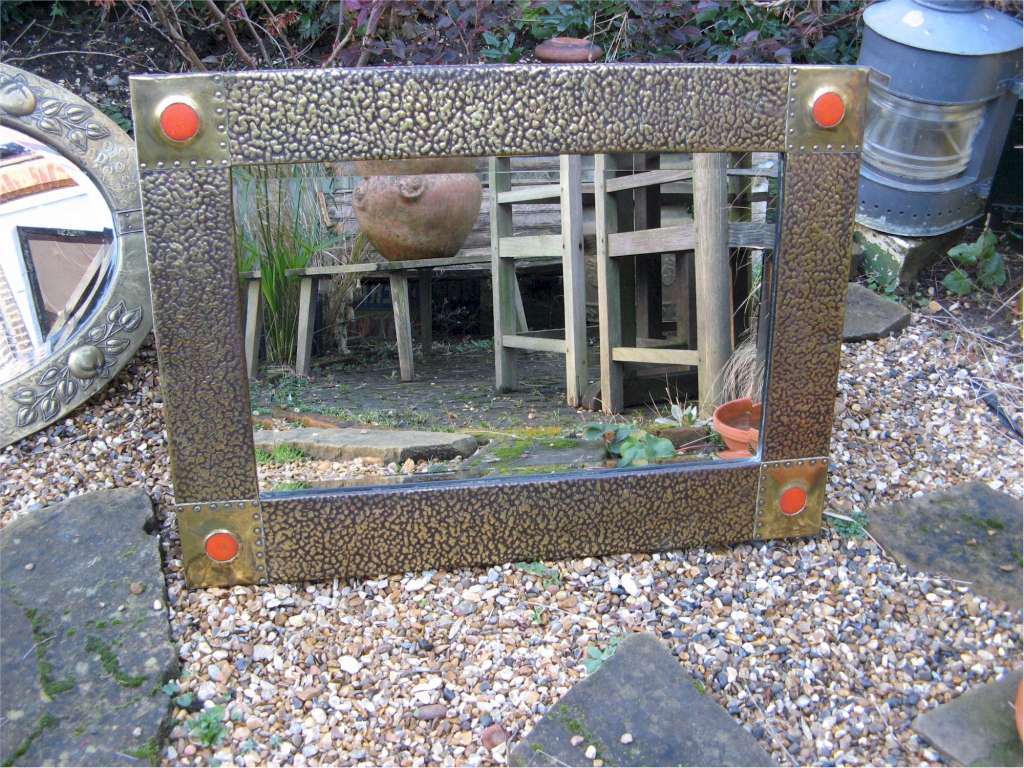 Large arts and crafts hammered  brass framed mirror with orange Ruskin type roundels