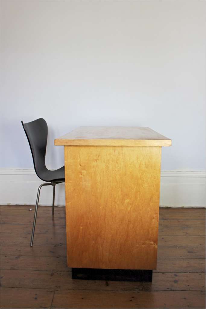 Modernist plywood birch desk with black handles and plinth