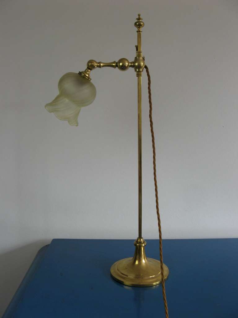 Arts and Crafts adjustable table lamp in brass with period shade . Made by Faraday and Son.