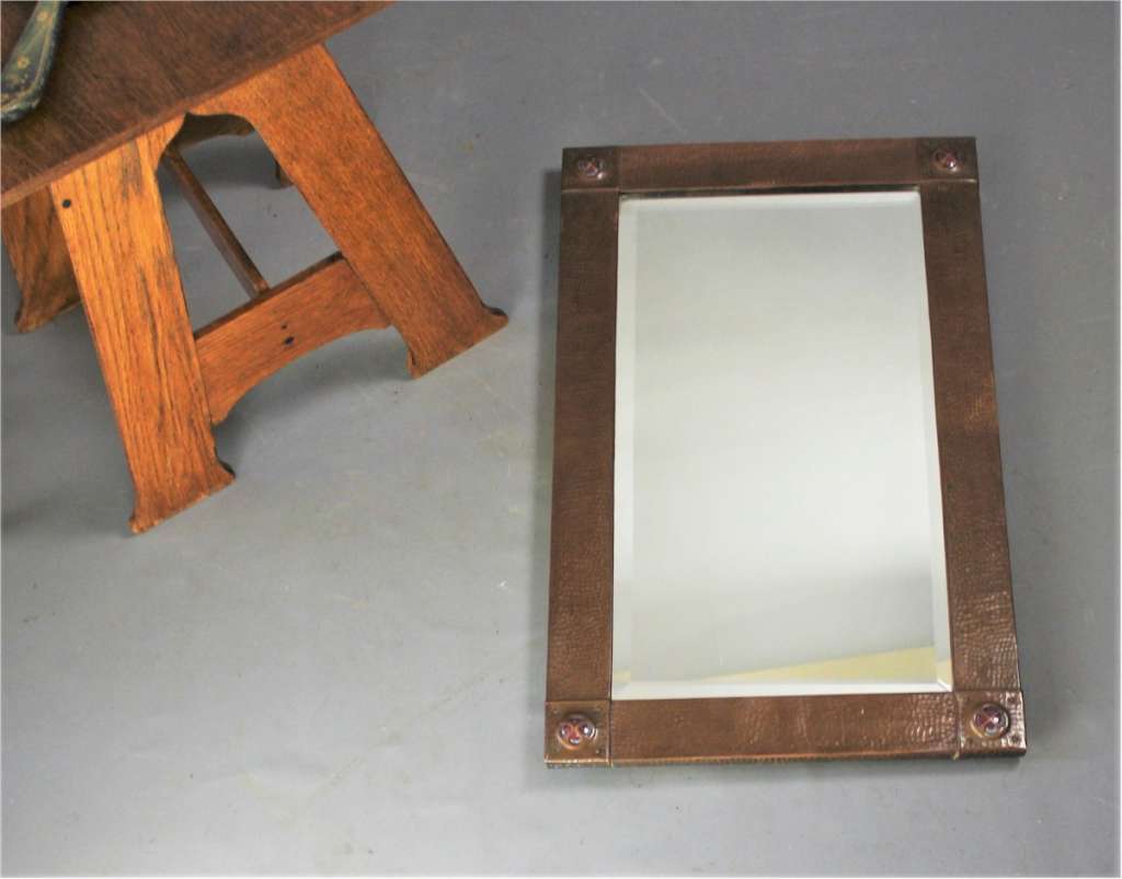 Copper arts and crafts mirror with Ruskins.