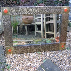 Large arts and crafts hammered  brass framed mirror with orange Ruskin type roundels