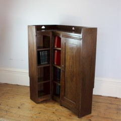 Rare Arts and Crafts Liberty & Co corner bookcase with pierced hearts