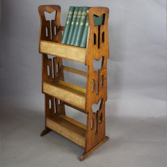 Arts and Crafts oak book trough with stylised pierced sides