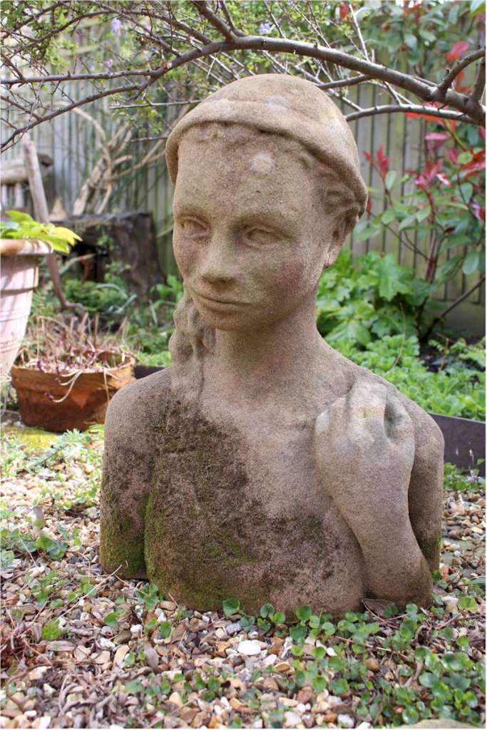 Garden statue in sandstone of an Island girl
