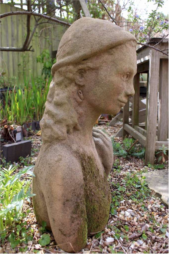 Garden statue in sandstone of an Island girl