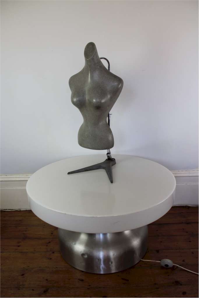 Shop fitting female torso in grey molded plastic on adjustable chrome stand