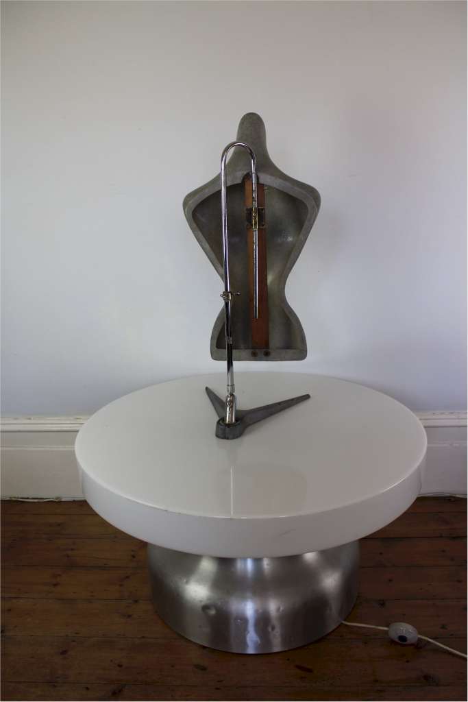 Shop fitting female torso in grey molded plastic on adjustable chrome stand