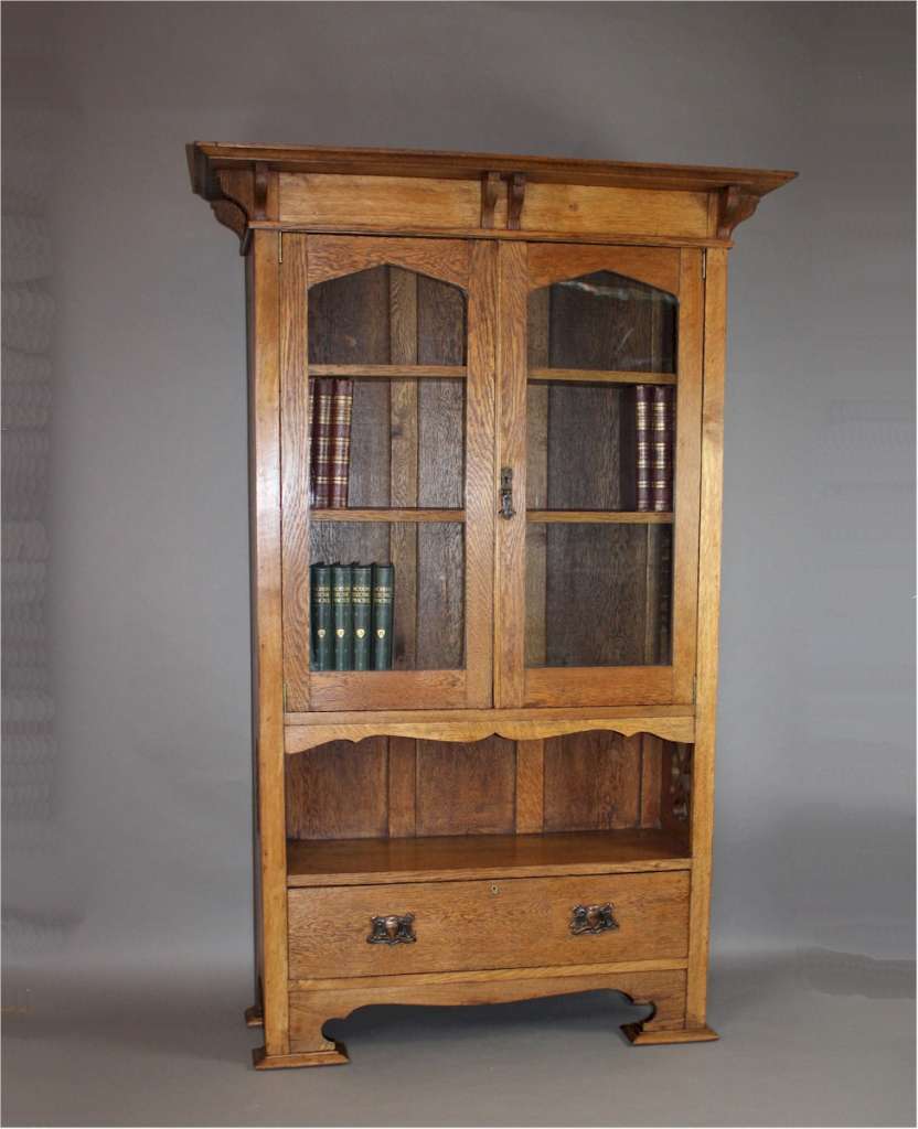 Arts and Crafts cottage oak glazed bookcase with pierced cut-outs