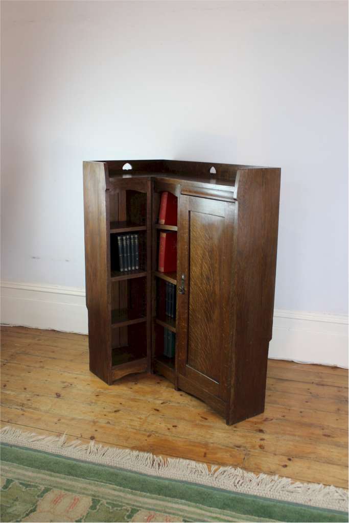 Rare Arts and Crafts Liberty & Co corner bookcase with pierced hearts