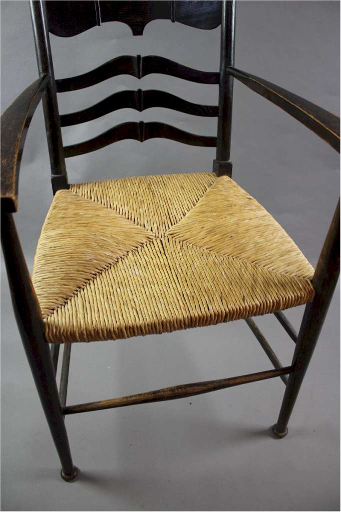 Arts and Crafts elbow chair with rush seat.