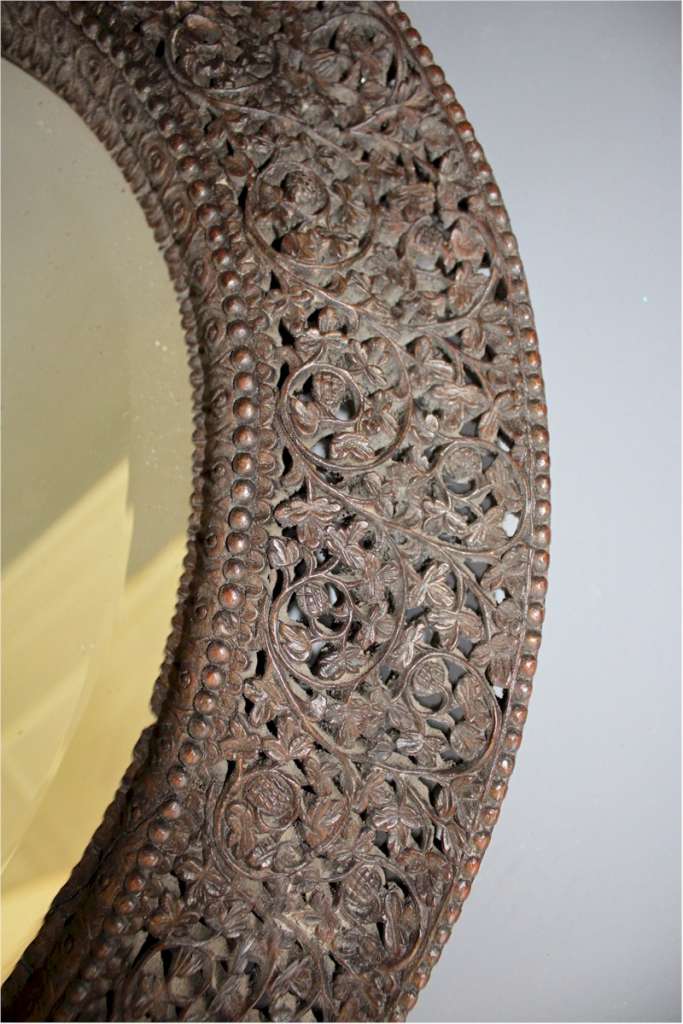 Antique Burmese carved hard wood oval wall mirror.