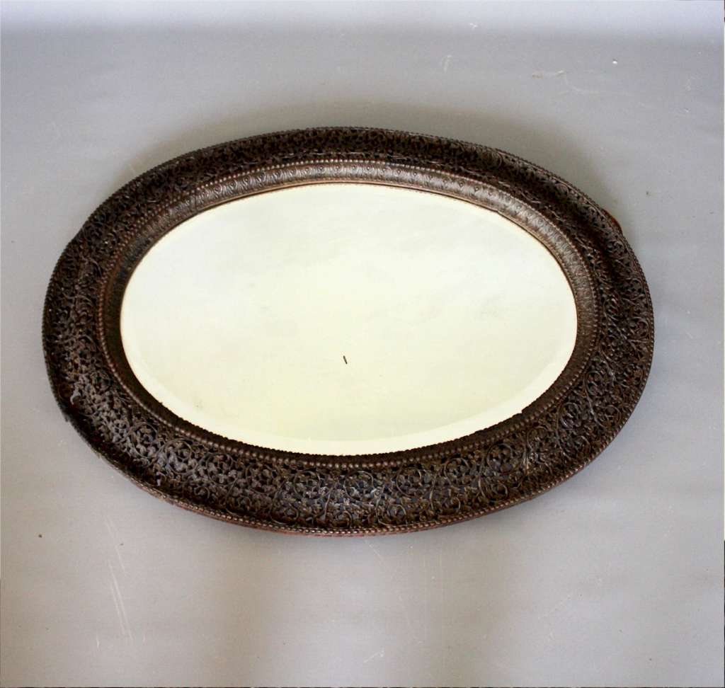 Antique Burmese carved hard wood oval wall mirror.