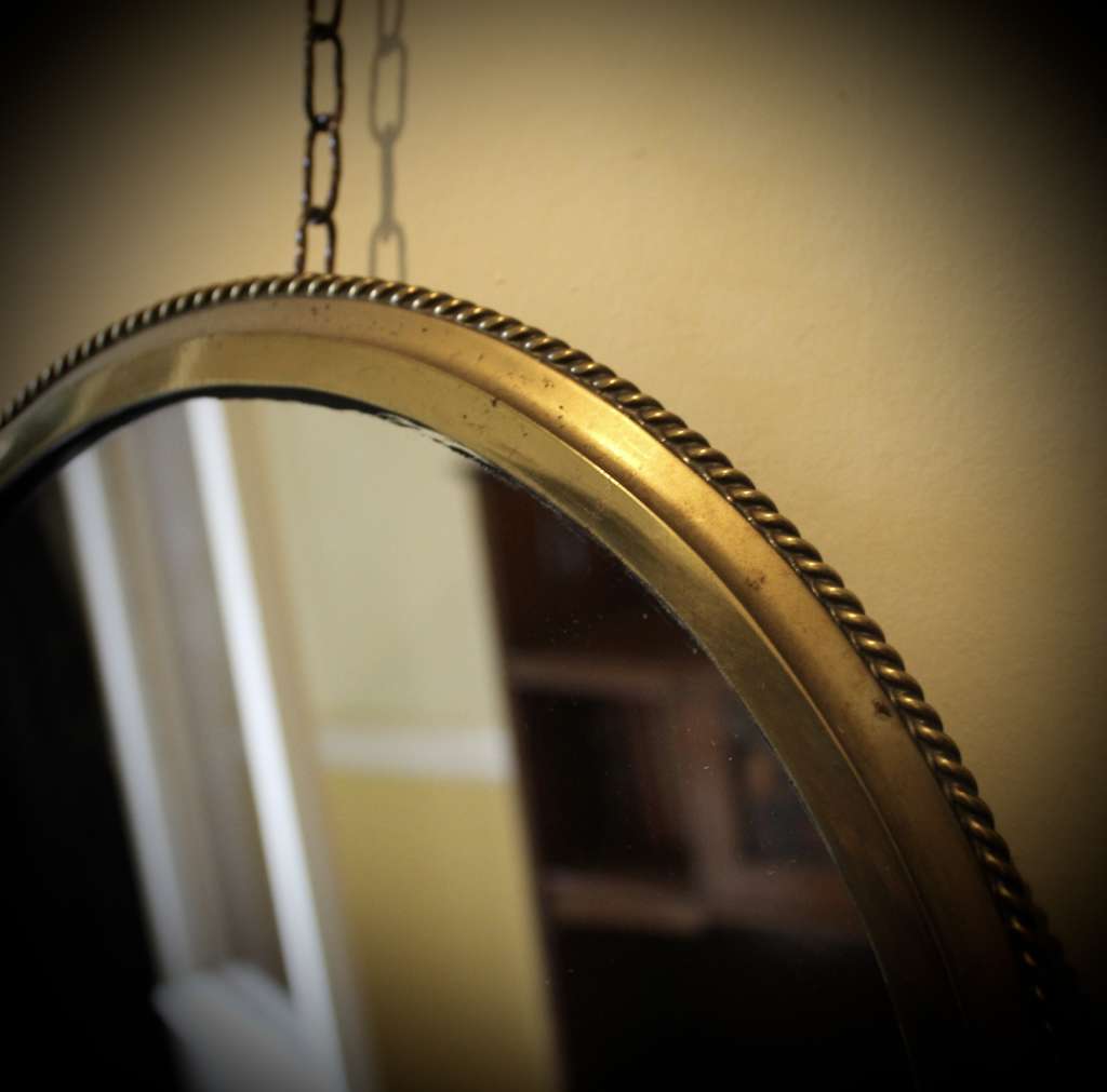 Circular brass ribbed wall mirror