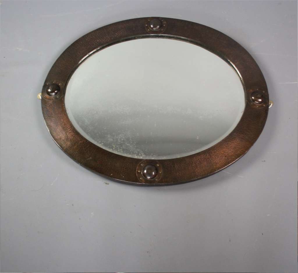 Arts and crafts oval copper mirror with raised roundels