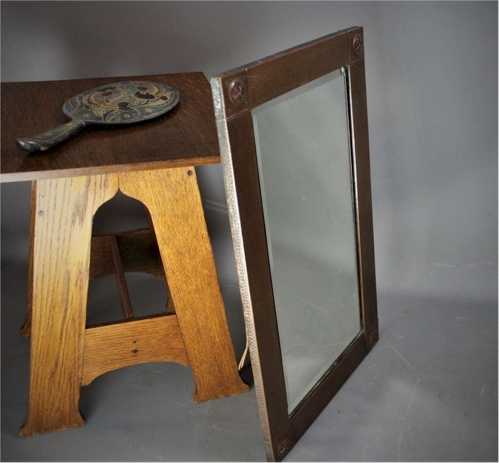 Copper arts and crafts mirror with Ruskins.