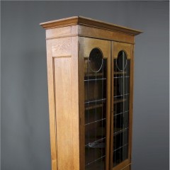 Arts and Crafts oak pewter and ebony inlaid glazed bookcase