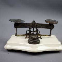 Ceramic and brass postal scales.